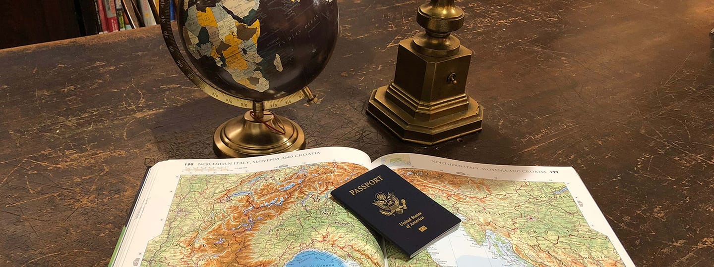 a passport on an atlas